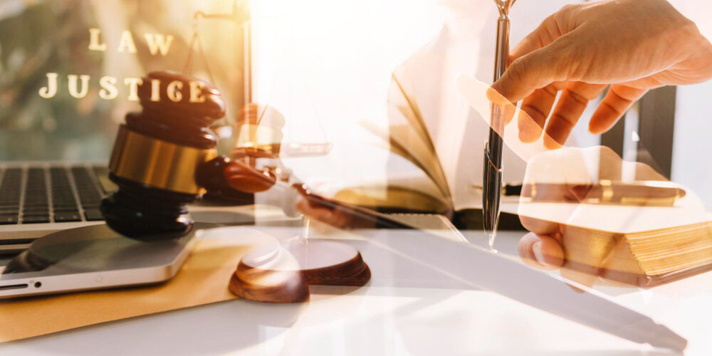 business-lawyers-discussing-contract-papers-with-brass-scale-desk-office-law-legal-services-advice-justice-law-concept