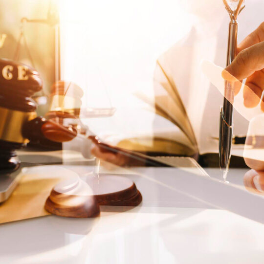 business-lawyers-discussing-contract-papers-with-brass-scale-desk-office-law-legal-services-advice-justice-law-concept